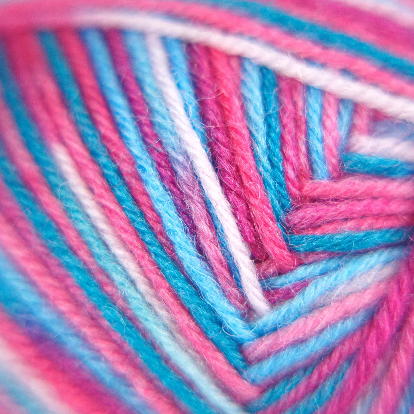 Macro close-up of Sock Flock – Sakura Spring yarn strands showing vivid pink, aqua blue and white fibre tones