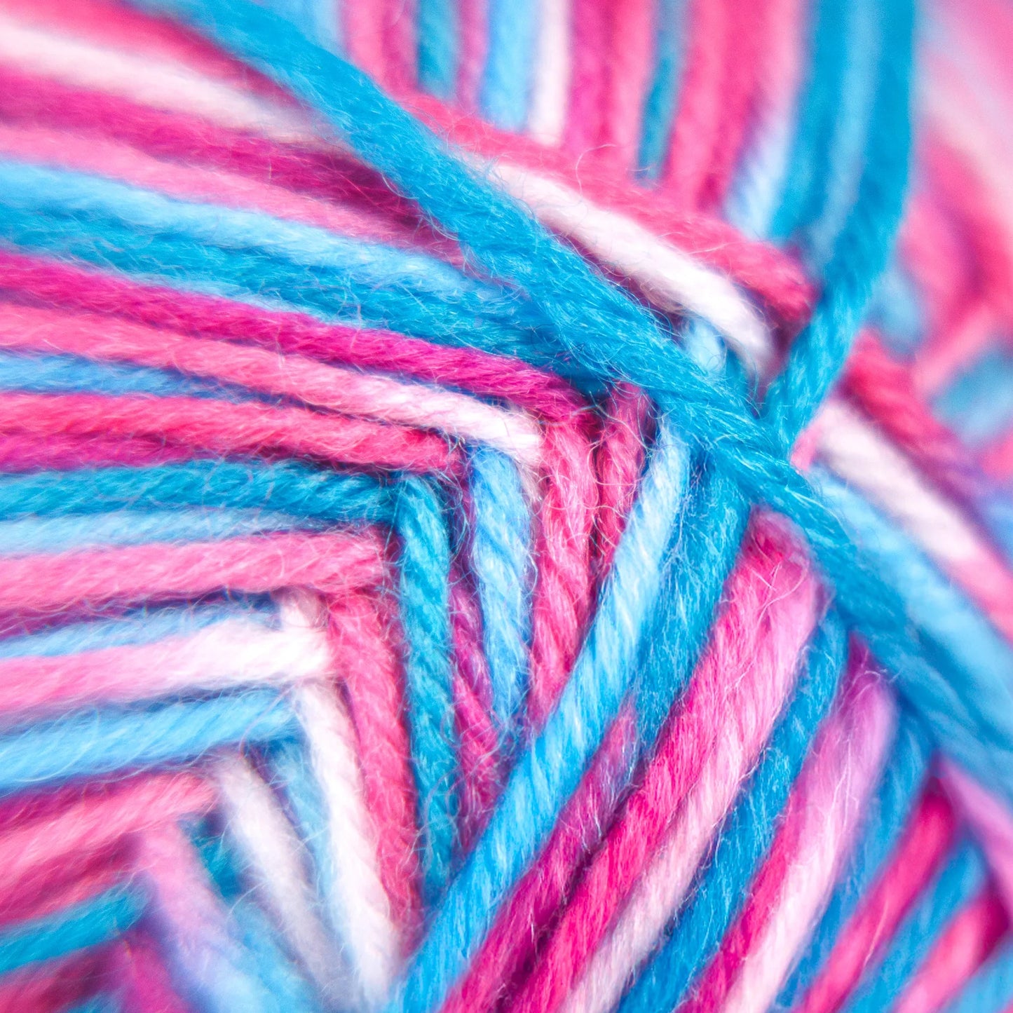 Extreme close-up of Sock Flock – Sakura Spring yarn with visible fibre texture in pink, blue and white hues