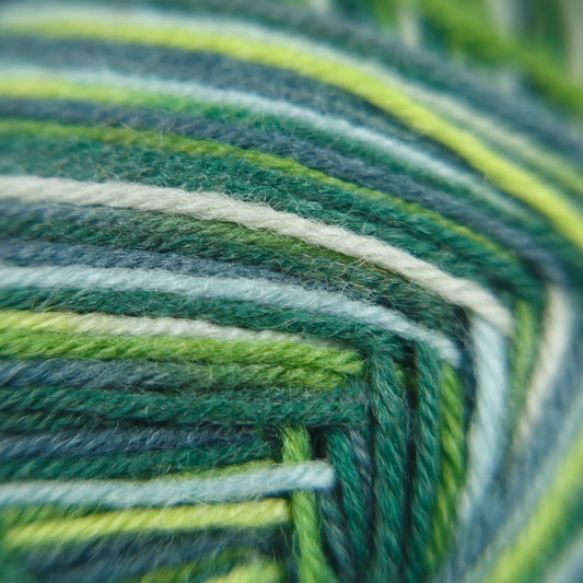 Fibre-level close-up of Sock Flock Wild Pear yarn strands with pink, aqua, and neutral blends