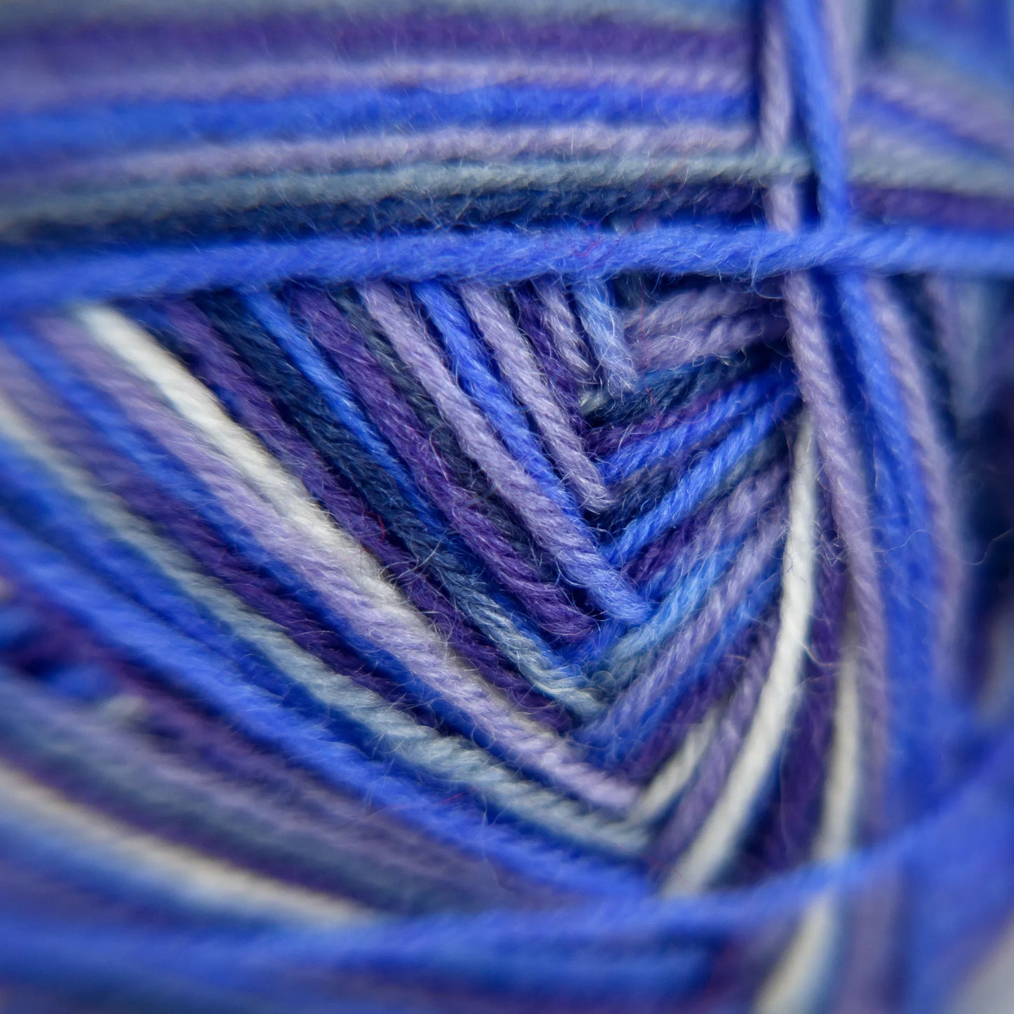Close-up of Blue Moon yarn fibre blend. Vivid indigo and aquamarine tones captured under natural light.