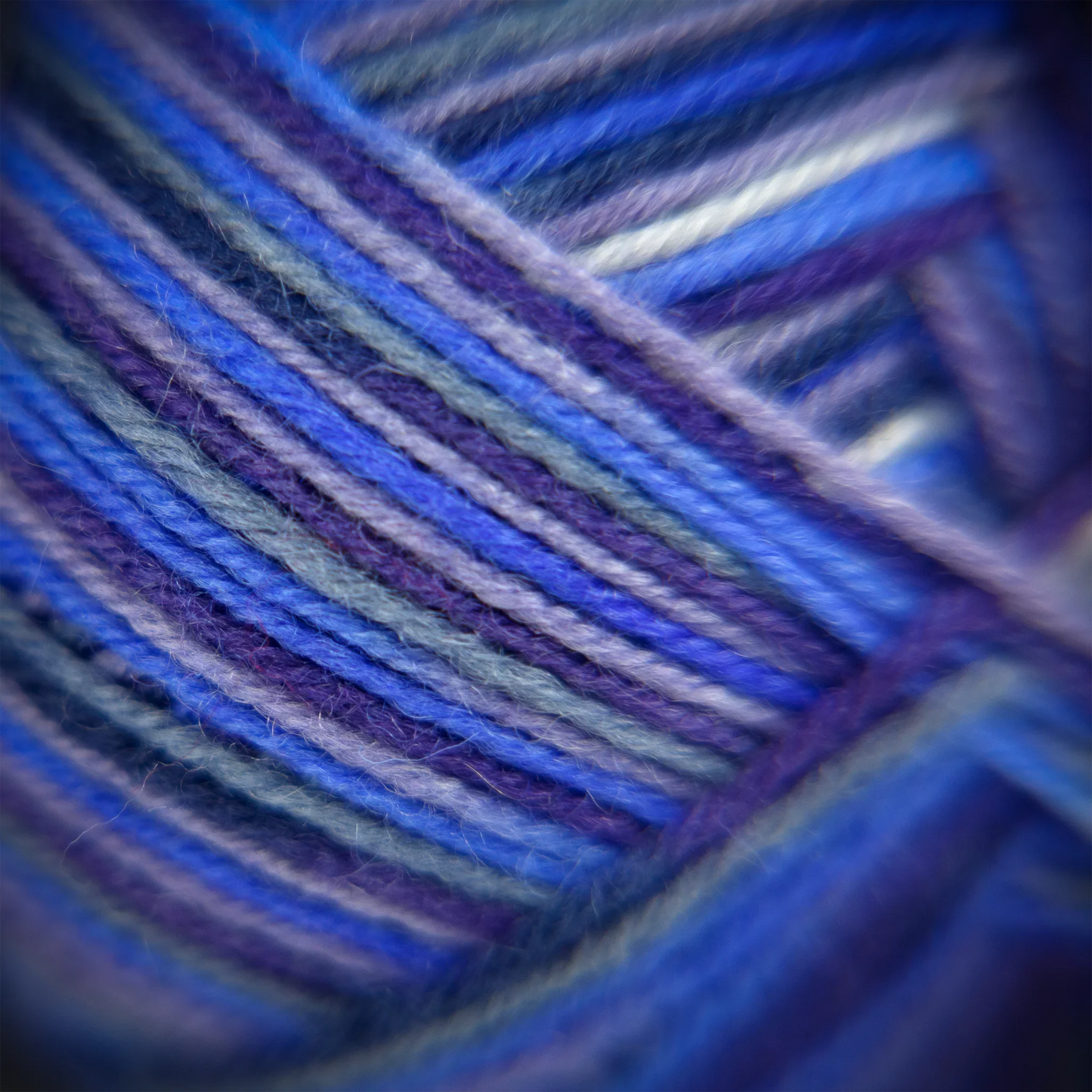 Detailed macro photo of Blue Moon yarn fibres, showing subtle variegation and softness. 420m per 120g ball.