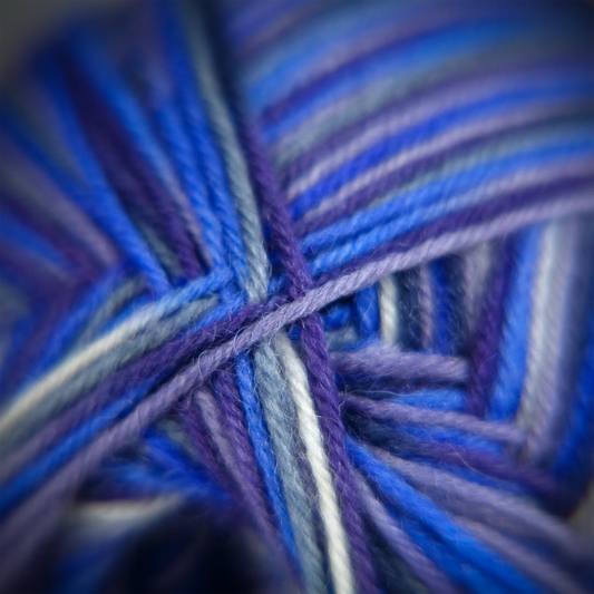 Close-up of ‘Blue Moon’ sock yarn in rich teal, indigo and night sky tones. Smooth 4-ply blend ideal for socks.