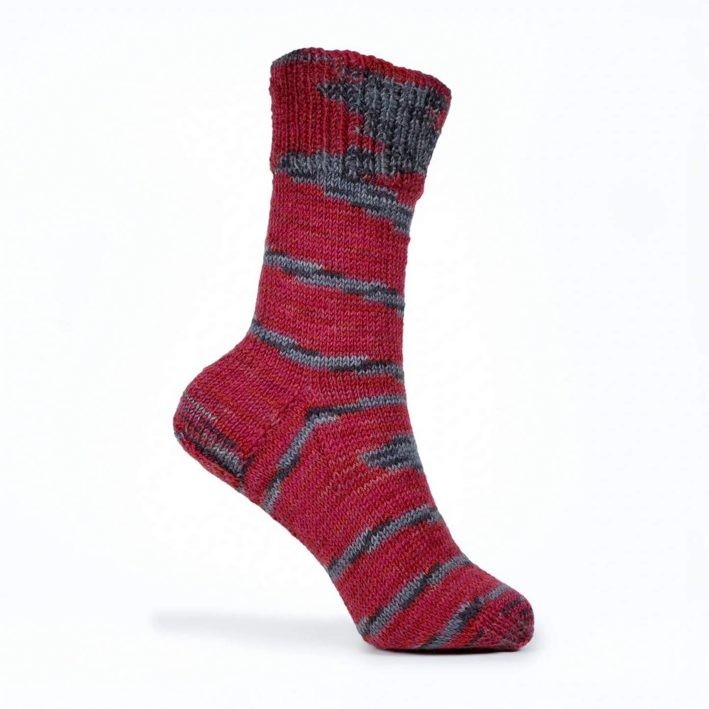 Right sock knitted in Roasted Fig yarn, displayed on mannequin foot against white background with natural stripe flow.