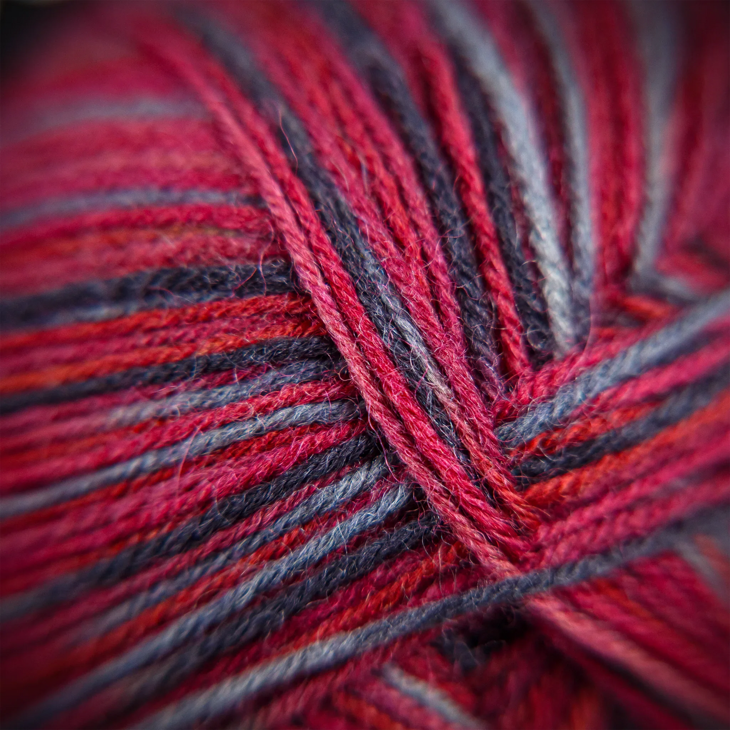 Close-up of Sock Flock ‘Roasted Fig’ yarn showing natural twist and layered tone variations.