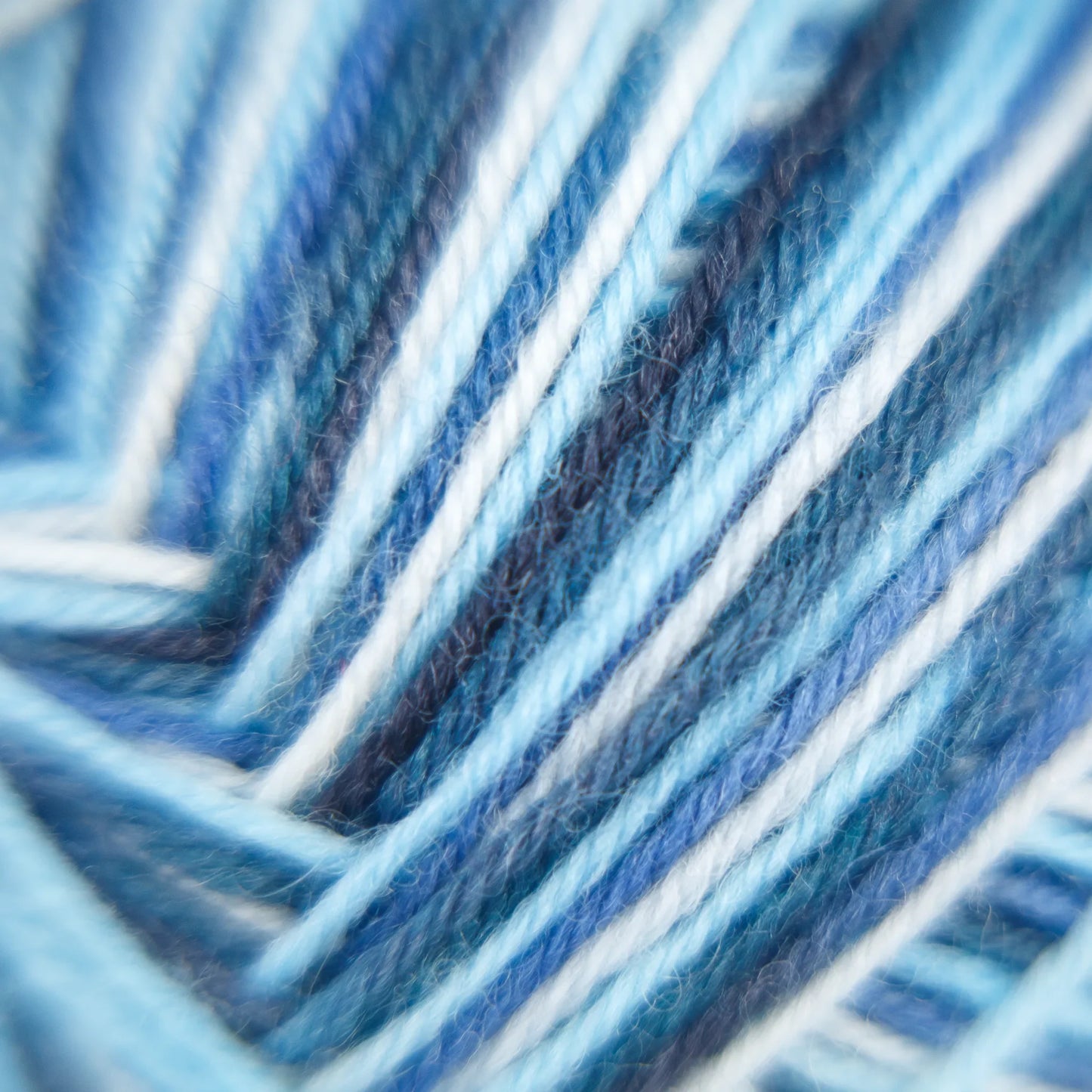 Macro close-up of Arctic Ocean yarn with balanced ply and blended tonal blue strands.