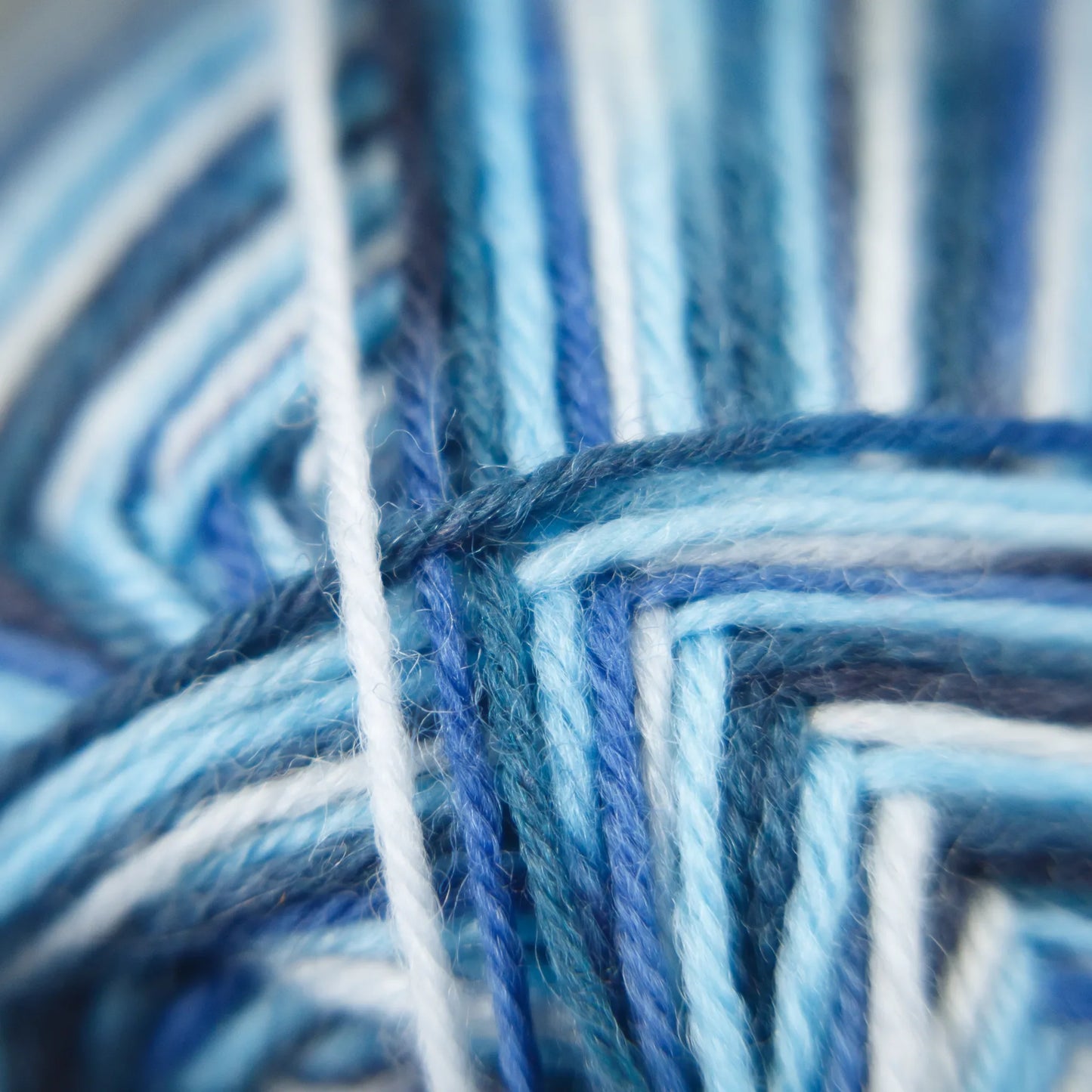 Close-up of Arctic Ocean yarn with crisp colour transitions and soft high-twist fibre texture.