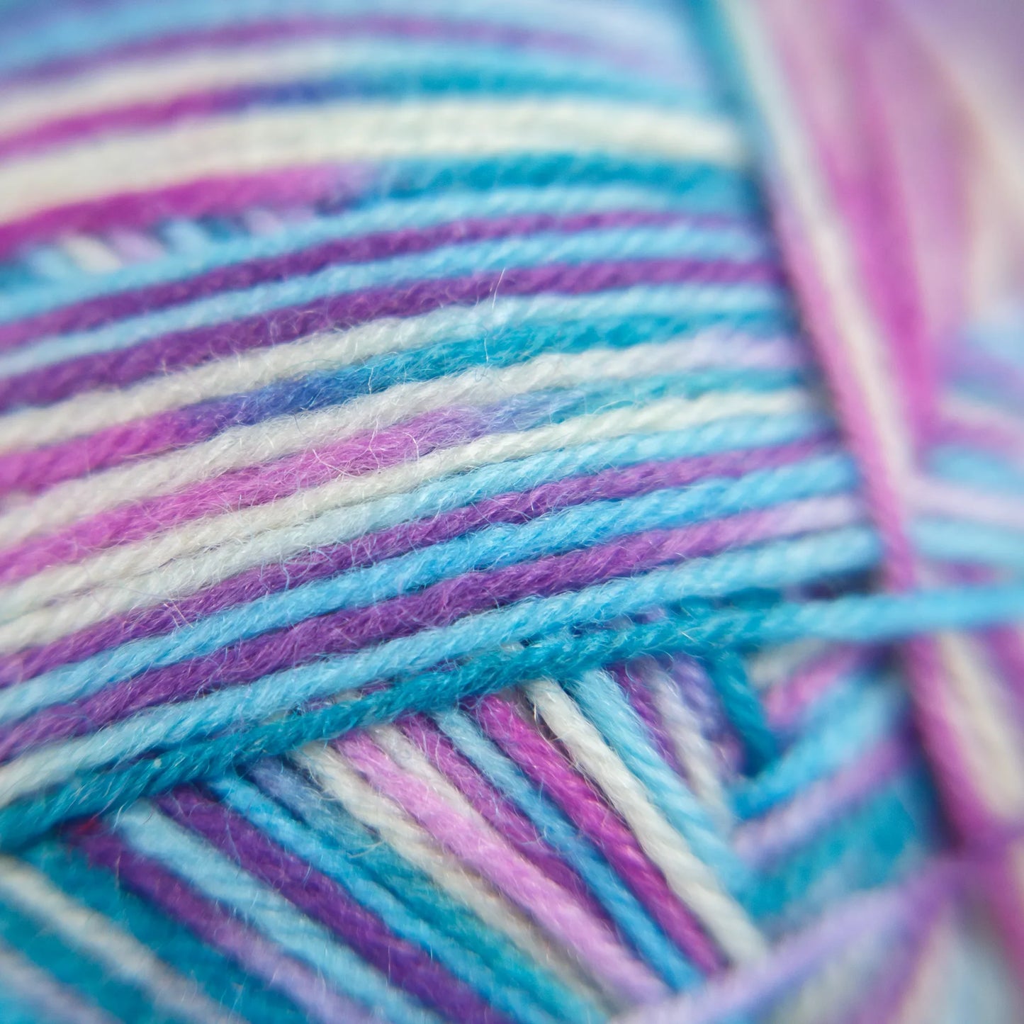 Macro image of Sea Glass yarn showing delicate shift between green-glass tones and creamy white.