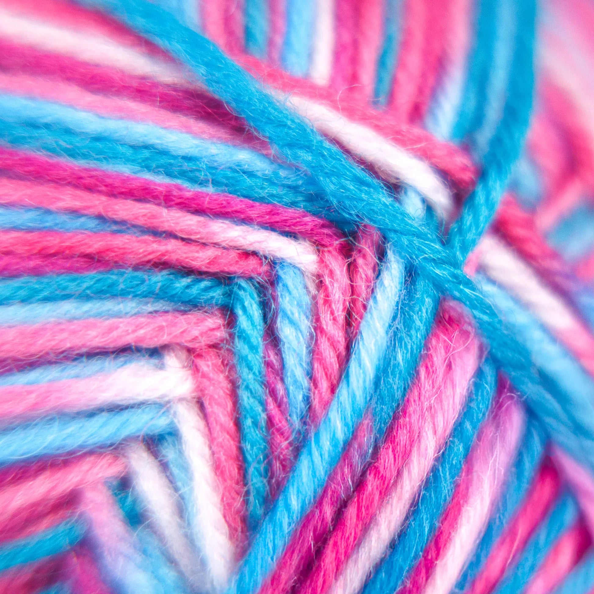 Extreme close-up of Sock Flock – Sakura Spring yarn with visible fibre texture in pink, blue and white hues