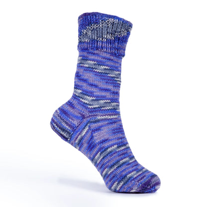 Right sock display of ‘Blue Moon’ yarn, modelled on white plastic foot form. Variegated stripes visible.