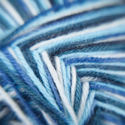 Macro of Sock Flock Arctic Ocean yarn, showing tonal blue, off-white and steely grey ply.