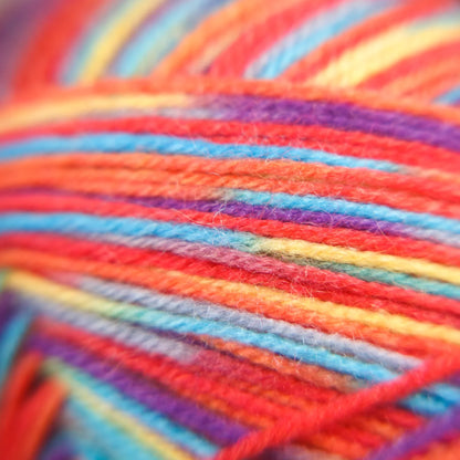 Macro view of Rainbow Reef yarn in variegated tones, showing balanced strand blending and soft texture.