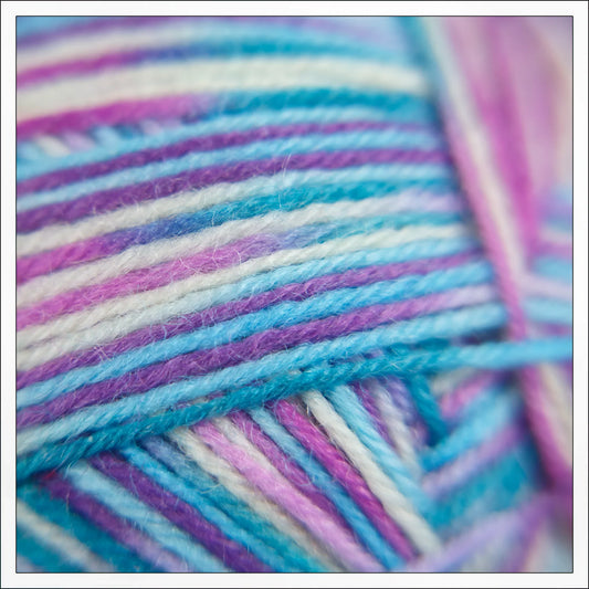 Square crop close-up of Sea Glass yarn with pale green-blue hues and gentle variegation.